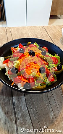 Salad greensalad green vegetables olive black olives carrot pickles tomato Stock Photo