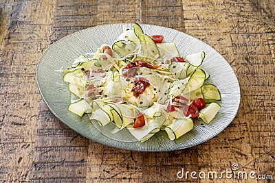 Salad with Italian burrata cheese, zucchini slices, cherry tomatoes, striped cheese and piquillo pepper Stock Photo