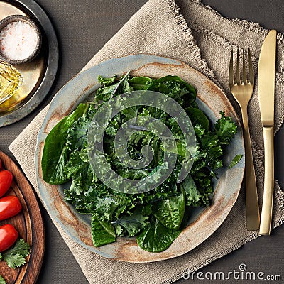 Salad kale, leaf cabbage, cos lettuce green mixture in plate. Undressed fresh leaves. Vegan Stock Photo