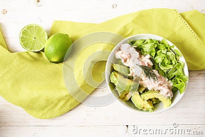 Salad from lettuce, crabs in cream and avocado in a bowl, green Stock Photo