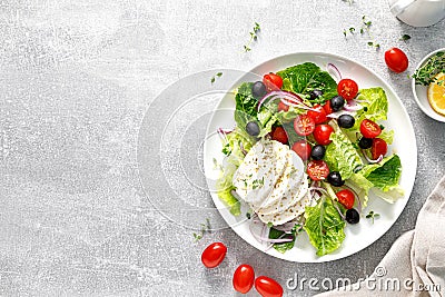 Salad with mozzarella cheese, cherry tomato, olives and romain lettuce, top view Stock Photo