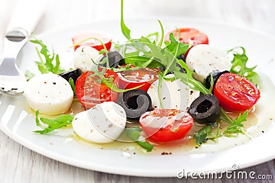 Salad with mozzarella, tomatoes and black olive Stock Photo