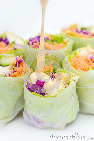 salad roll made from vegetable ingredients such as carrots, green cabbage, purple cabbage, cucumber, and roasted chicken Stock Photo