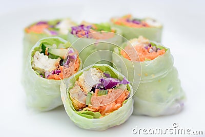 salad roll made from vegetable ingredients such as carrots, green cabbage, purple cabbage, cucumber, and roasted chicken Stock Photo