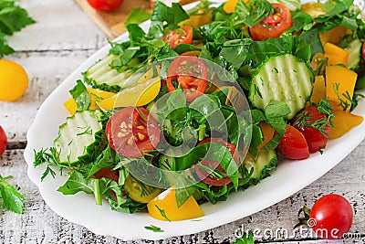 Salad of tomatoes, cucumbers, peppers, arugula and dill. Stock Photo