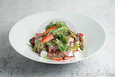 Salad with warm chicken liver, fresh strawberries and vegetables Stock Photo