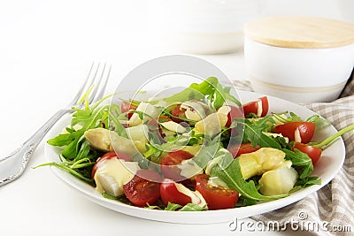 Salad with white asparagus, cocktail tomatoes and rucola, health Stock Photo