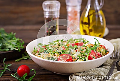 Salads with quinoa, arugula, radish, tomatoes and cucumber Stock Photo