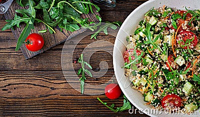 Salads with quinoa, arugula, radish, tomatoes and cucumber Stock Photo