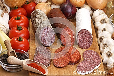Salami and slices salami on a timber board Stock Photo