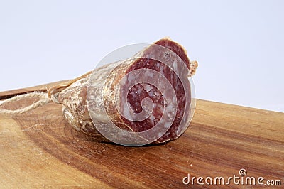 Salami on wood trencher Stock Photo