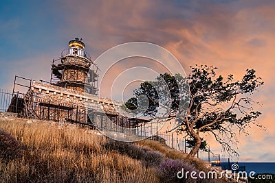 Salamis island, Greece. The stone built lighthouse at cape Koghi on sunse timet Stock Photo