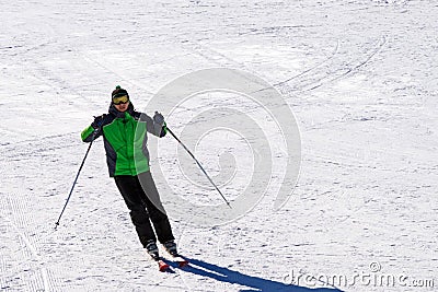 Skier goes downhill on a downhill skis from a mountain slope Editorial Stock Photo