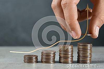 Salary increase concept. Woman stacking coins on grey table and illustration of up arrow Cartoon Illustration