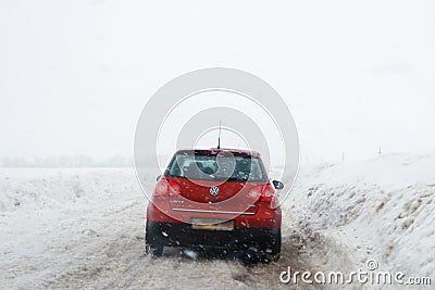 Salavat, Russia - February 26, 2017: dangerous driving, road with car in blizzard Editorial Stock Photo