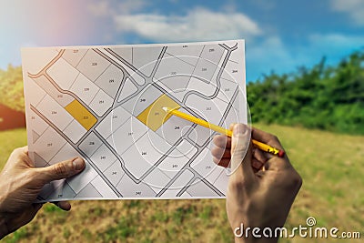 Sale of building plot of land for house construction. cadastral map on field background Stock Photo