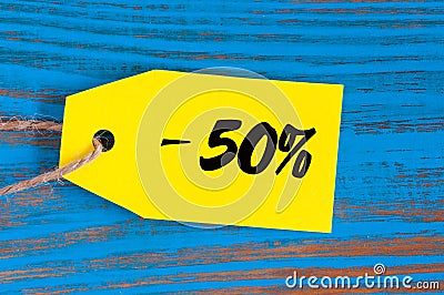 Sale minus 50 percent. Big sales fifty percents on blue wooden background for flyer, poster, shopping, sign, discount Stock Photo