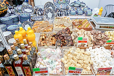 Sale of oriental sweets and ceramic tableware at the fair. Editorial Stock Photo