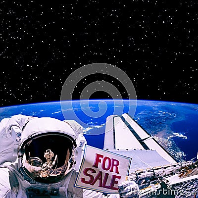 For sale sign in astronaut`s hand above earth. The elements of t Stock Photo