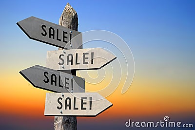 Sale! - wooden signpost, sunset sky Stock Photo