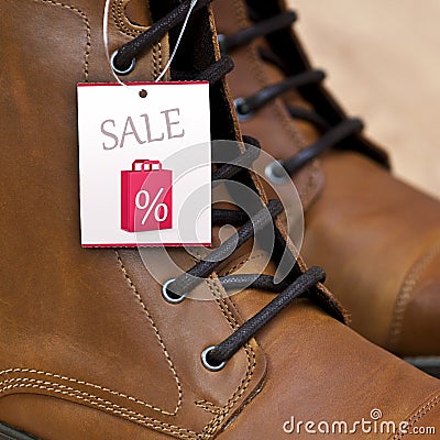 Sale Price Tag on Leather Boots Stock Photo