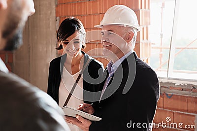 Sales Agent Showing New House To Husband And Wife Stock Photo