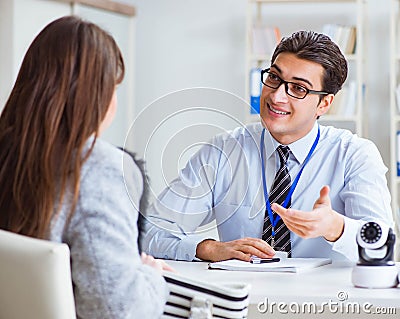 Sales assistant showing cameras to client in shop Stock Photo