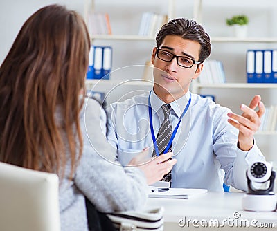 Sales assistant showing cameras to client in shop Stock Photo