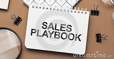 sales playbook on notepad with pen, glasses and calculator Stock Photo