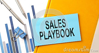 SALES PLAYBOOK text on sticker on the yellow notebook with chart and pen Stock Photo