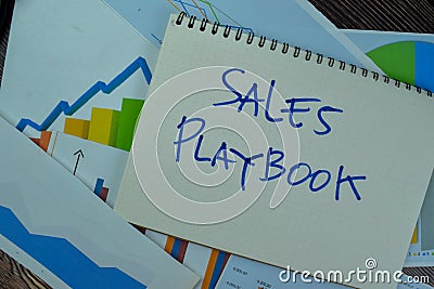 Sales Playbook write on a book isolated on Wooden Table Stock Photo