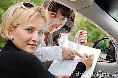 Saleslady assisting a customer to buy a car Stock Photo