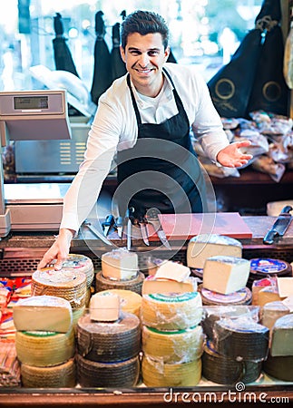 Salesman with cheese in gastronomy Stock Photo