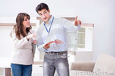 The salesman explaining to woman customer at furniture store Stock Photo