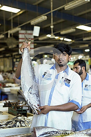 Salesman showing fresh salmon Fish slice, Dubai, United Arab Emirates Editorial Stock Photo