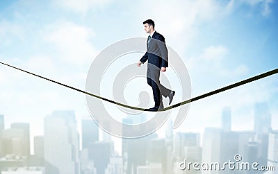 Salesman walking on rope above the city Stock Photo