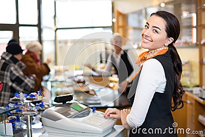 Salesperson at cash register Stock Photo