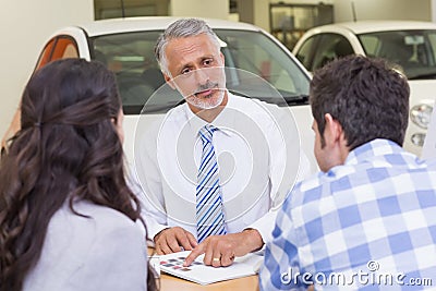 Salesperson pointing something on booklet Stock Photo