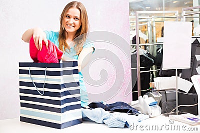 Salesperson Standing At Cash Register Stock Photo