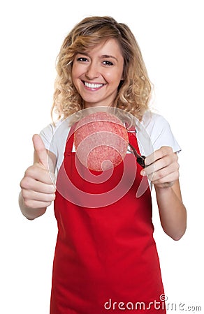 Saleswoman with blond hair recommending italian salami Stock Photo