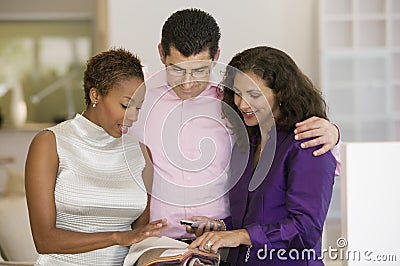 Saleswoman and Couple Examining Fabric Swatches Stock Photo