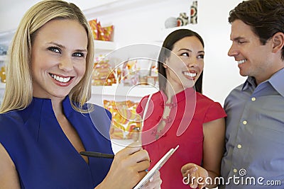 Saleswoman And Couple At Store Stock Photo