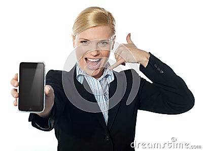 Saleswoman displaying new iphone to camera Stock Photo