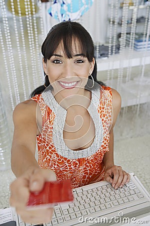 Saleswoman Handing Credit Card Back To Customer Stock Photo
