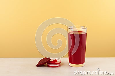 Salgam or fermented beet juice in tall grass. Turkish drink, made from fermented purple carrots, turnips or beets. Yellow Stock Photo