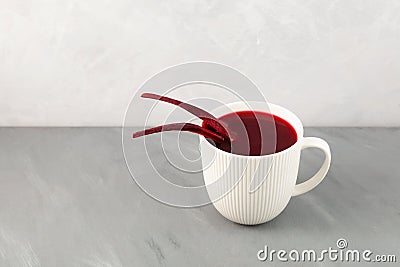 Salgam or fermented beet juice in white cup. Popular Turkish drink. Selective focus, copy space Stock Photo