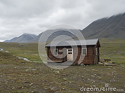 Salka, Norrbotten, Sweden, Agust 26, 2019: View on Salka STF mountain cabin hut. Green hills, and water puddles, cloudy rainy day Editorial Stock Photo