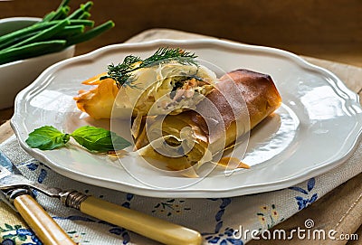 Salmon and basil butter filo parcels Stock Photo