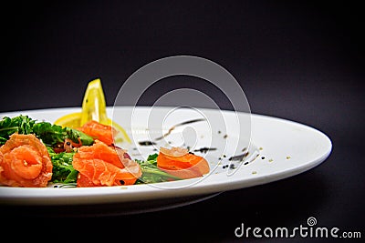 Salted salmon with garnish on black background Stock Photo