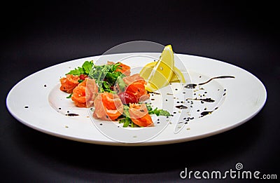 Salted salmon with garnish on black background Stock Photo